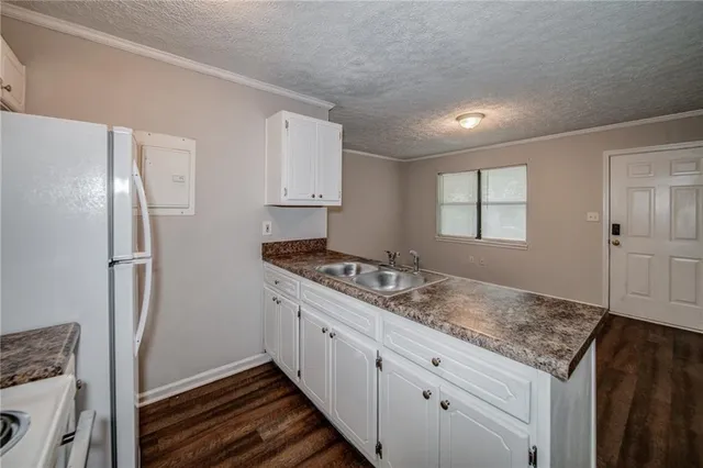 a kitchen with stainless steel appliances granite countertop a refrigerator and a sink