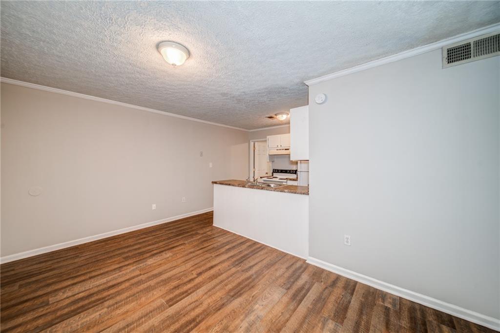 341 West Griffin Street, Unit C Dallas, GA 30132 - Photo 7 of 19 a view of a kitchen with wooden floor and a sink