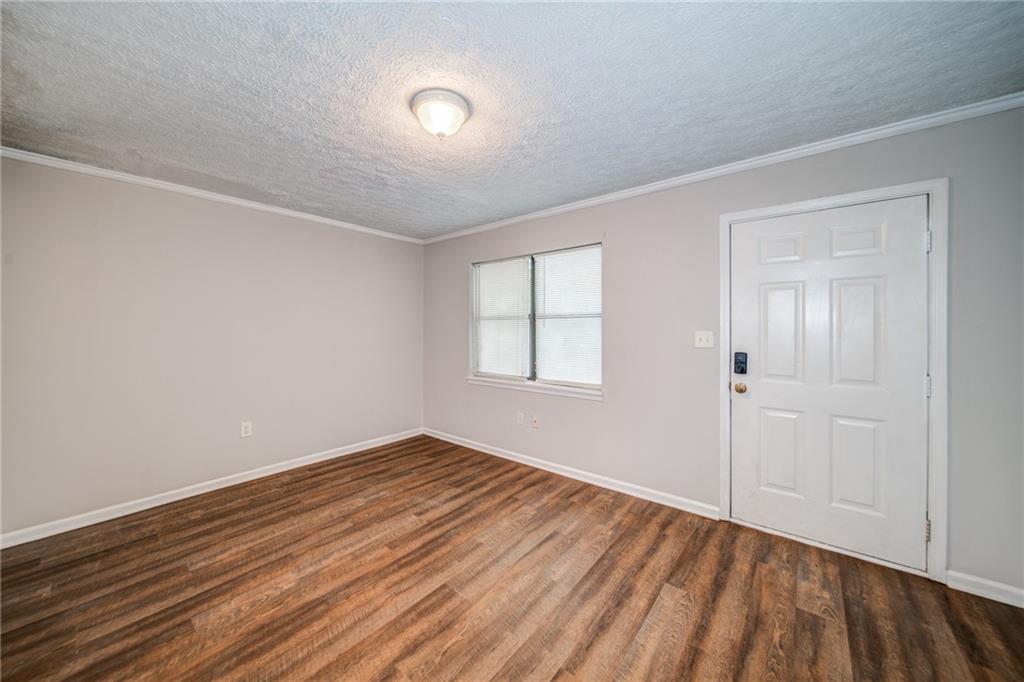 341 West Griffin Street, Unit C Dallas, GA 30132 - Photo 9 of 19 a view of an empty room with wooden floor and a window