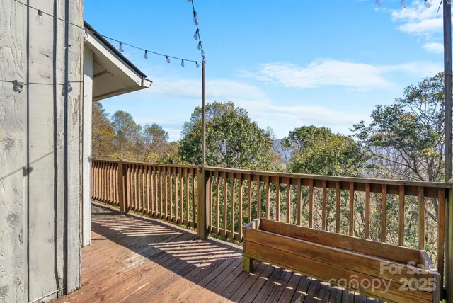 a view of balcony with wooden floor and fence