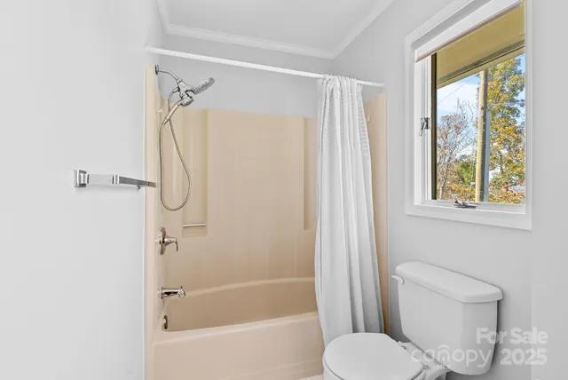 a white toilet sitting next to a bath tub shower