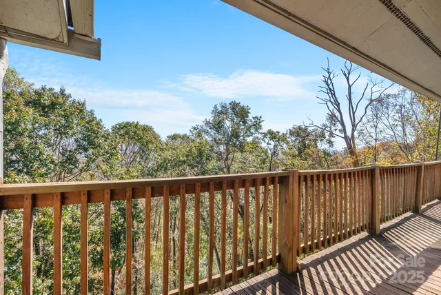 a balcony with wooden floor and fence