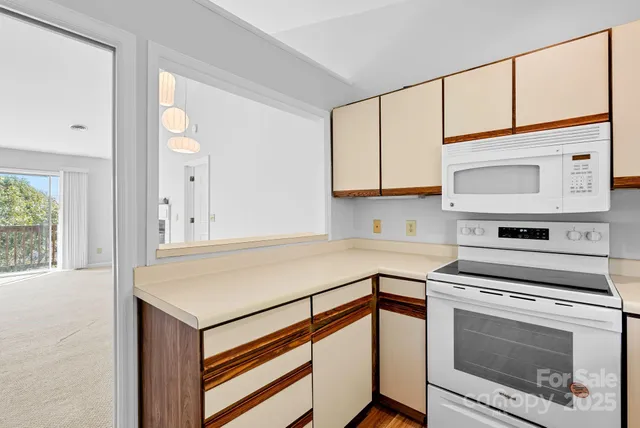 a kitchen with a stove cabinets and a microwave