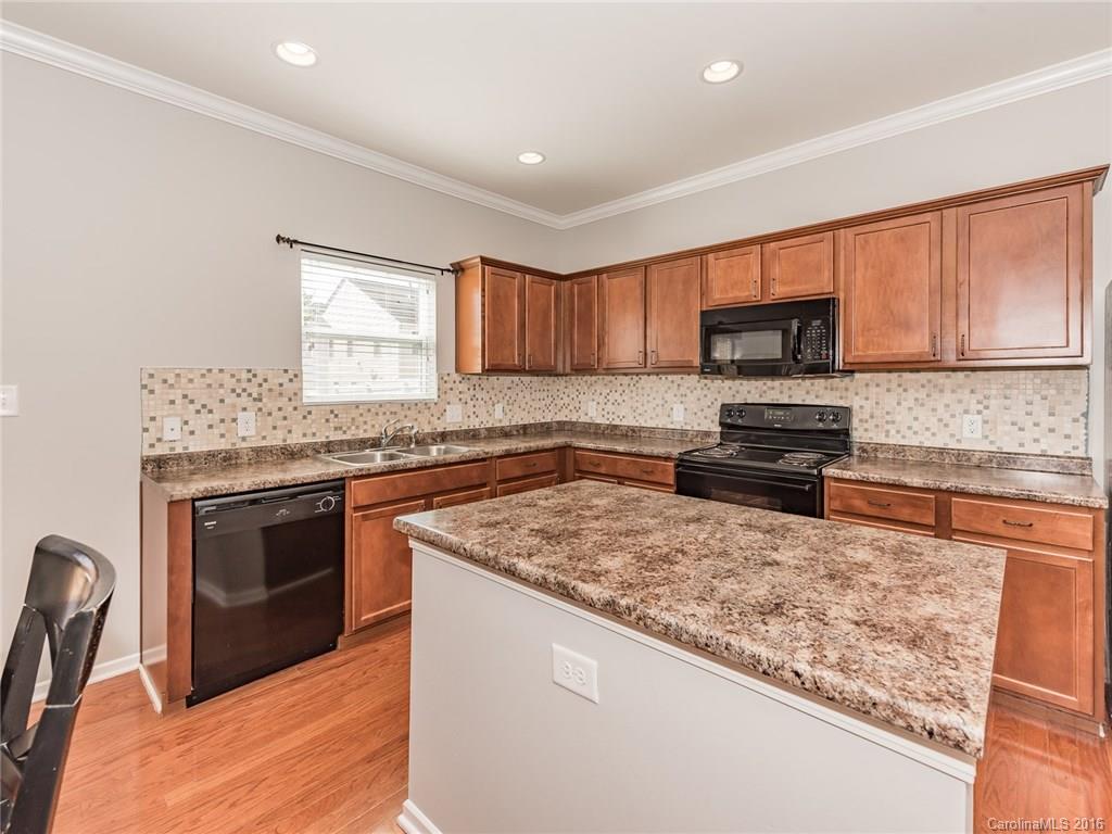 2226 Durand Road Fort Mill, SC 29715 - Photo 13 of 24 a kitchen with a stove a sink and a microwave