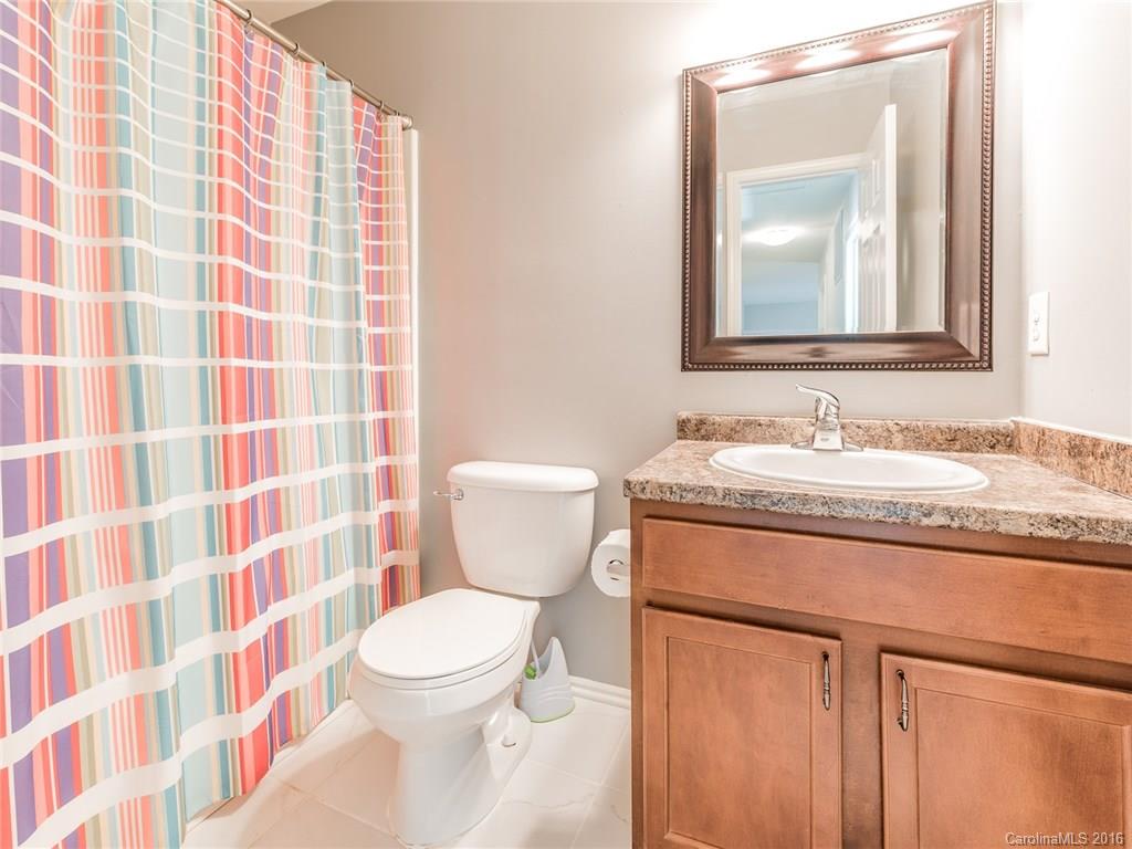 2226 Durand Road Fort Mill, SC 29715 - Photo 19 of 24 a bathroom with a granite countertop sink a toilet and a mirror