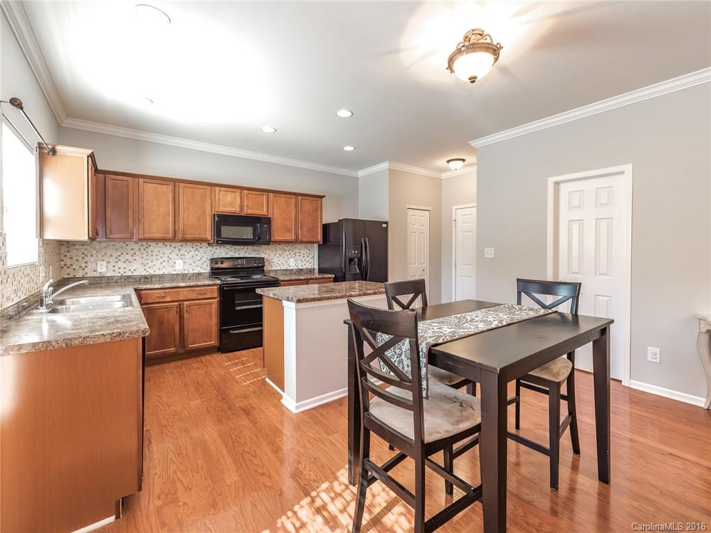 2226 Durand Road Fort Mill, SC 29715 - Photo 9 of 24 a kitchen with a table chairs microwave and cabinets