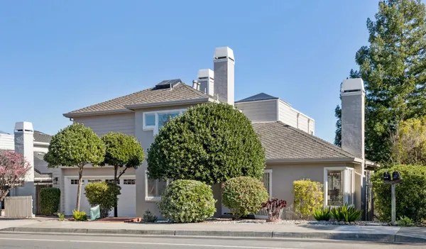 a front view of a house with garden