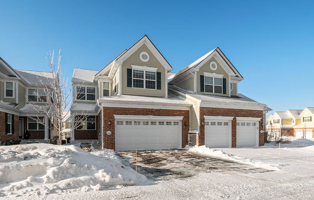 1244 Falcon Ridge Drive Elgin, IL 60124 - Photo 22 of 23 a front view of a house with a yard and garage