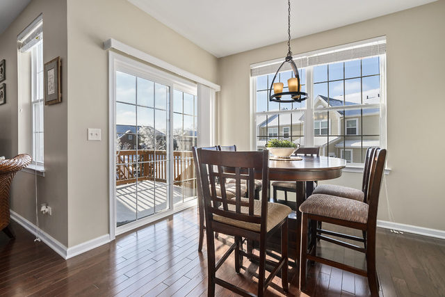 1244 Falcon Ridge Drive Elgin, IL 60124 - Photo 6 of 23 a dining room with furniture a chandelier and wooden floor