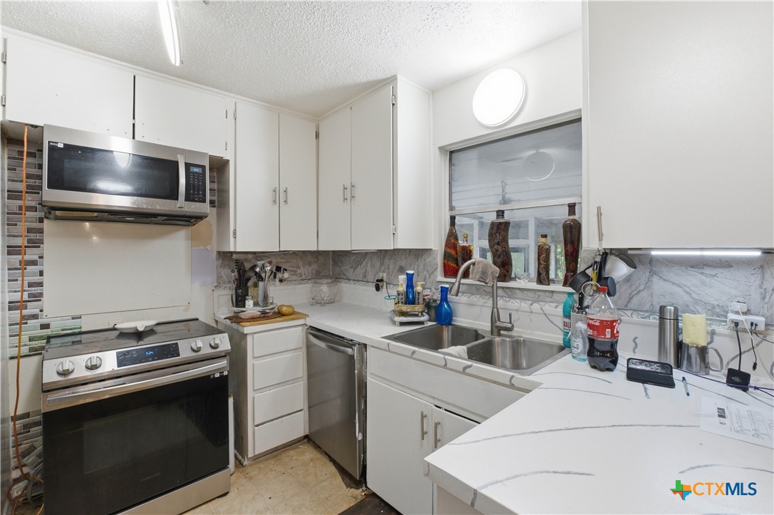 503 Cardinal Avenue Killeen, TX 76541 - Photo 12 of 26 a kitchen with a sink stove and microwave