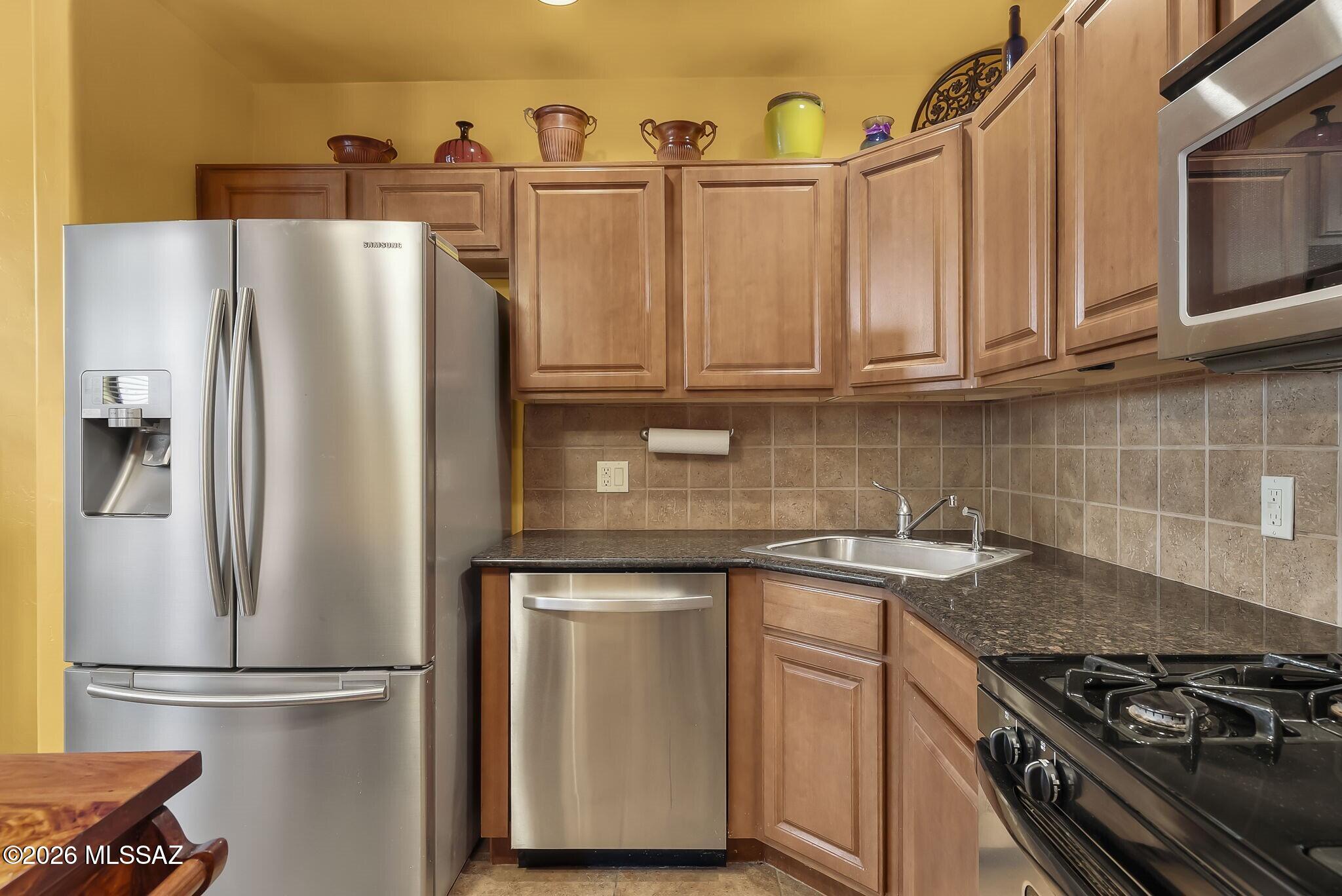 101 Post Way Tubac, AZ 85646 - Photo 9 of 31 a kitchen with stainless steel appliances granite countertop a refrigerator a stove and a sink