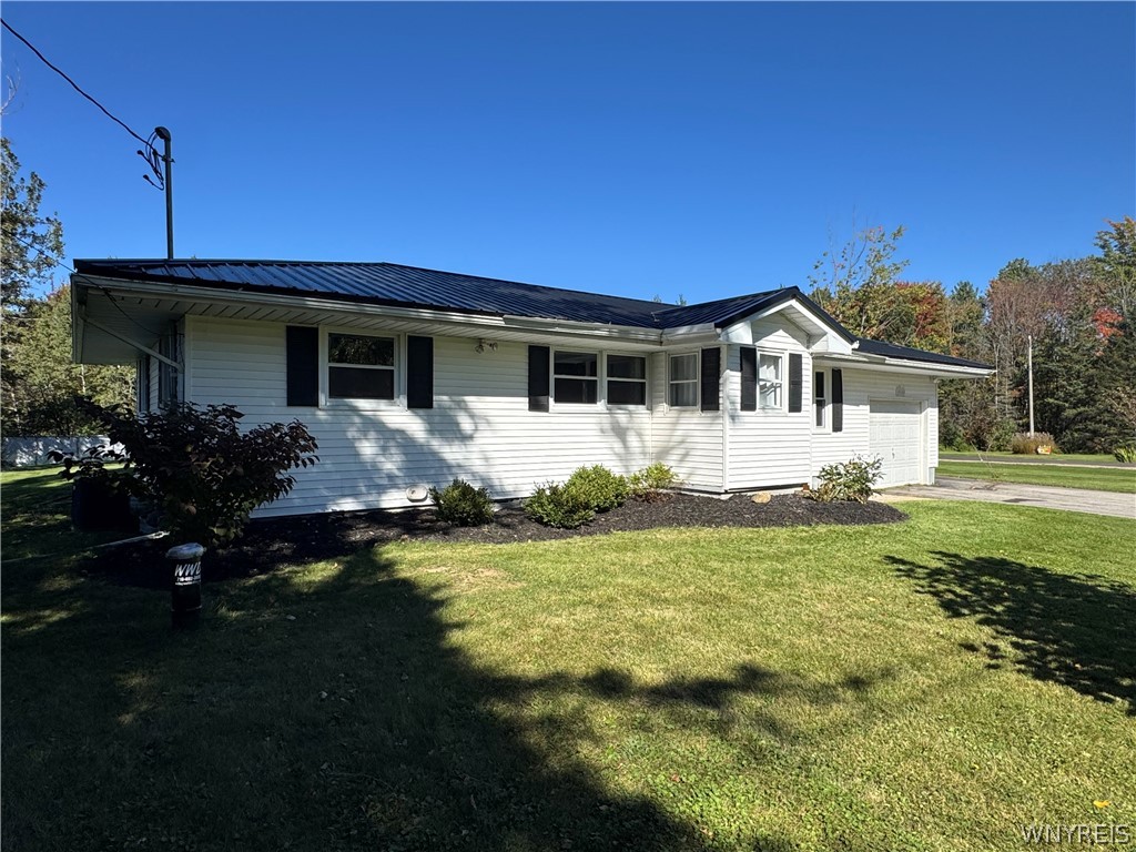 10180 Partridge Road Colden, NY 14080 - Photo 2 of 34 Crisp white siding contrasts beautifully with a dark metal roof and matching shutters.