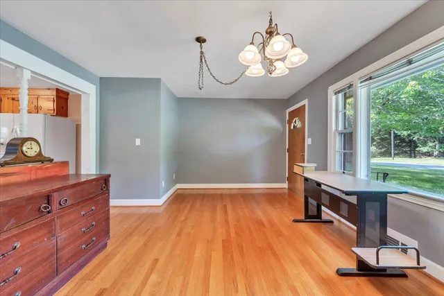 a view of an empty room with a fireplace and a window