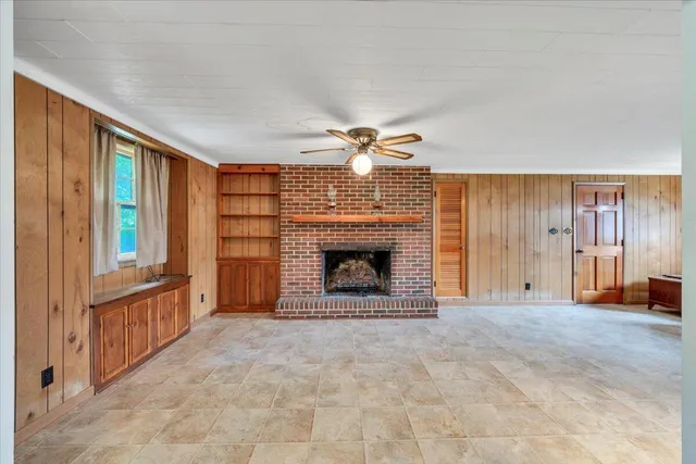 a kitchen with granite countertop wooden cabinets and a stove