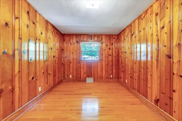 an empty room with a window and a ceiling fan