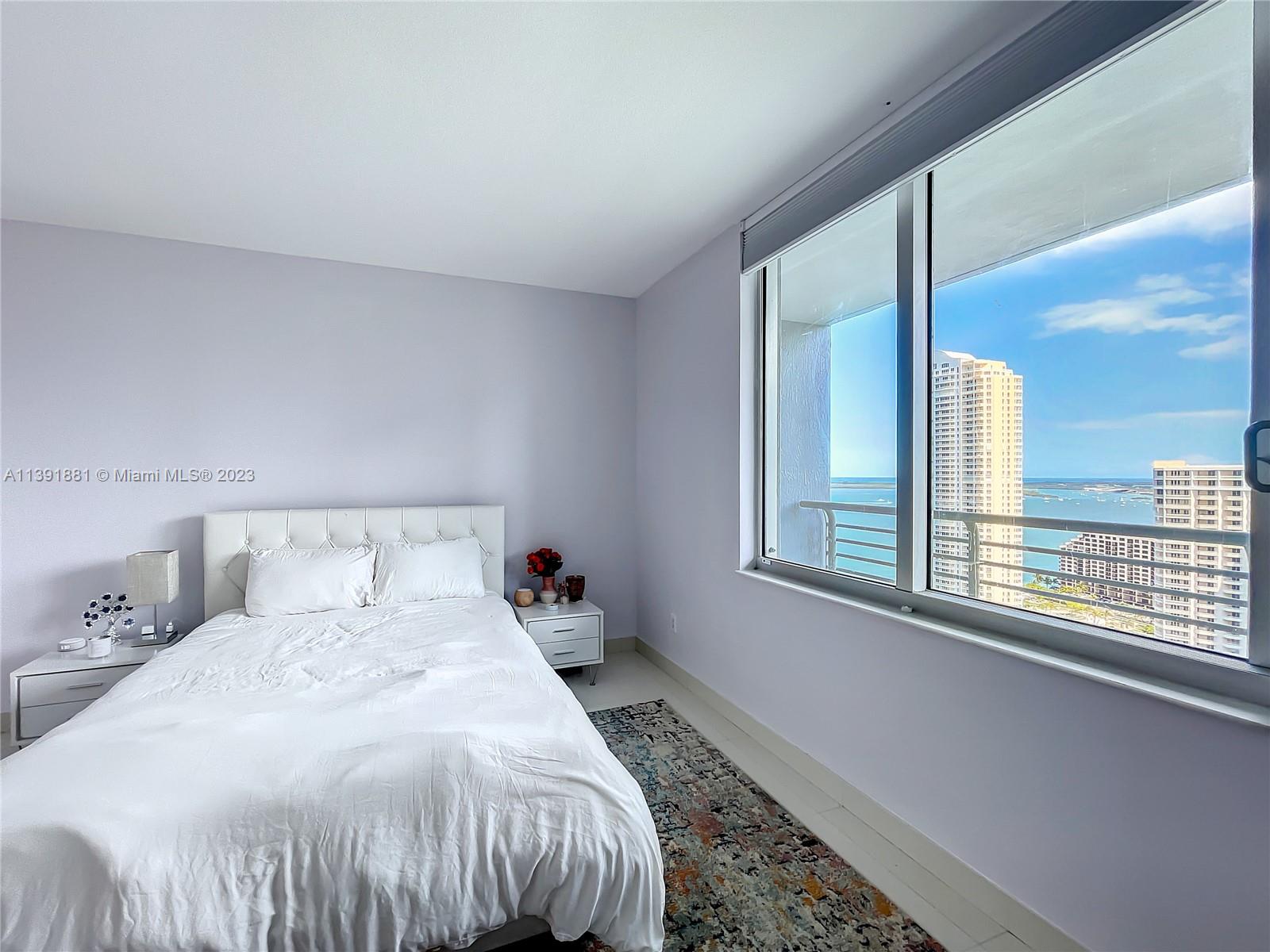 335 South Biscayne Boulevard, Unit 3103 Miami, FL 33131 - Photo 12 of 35 a bedroom with a bed and a window