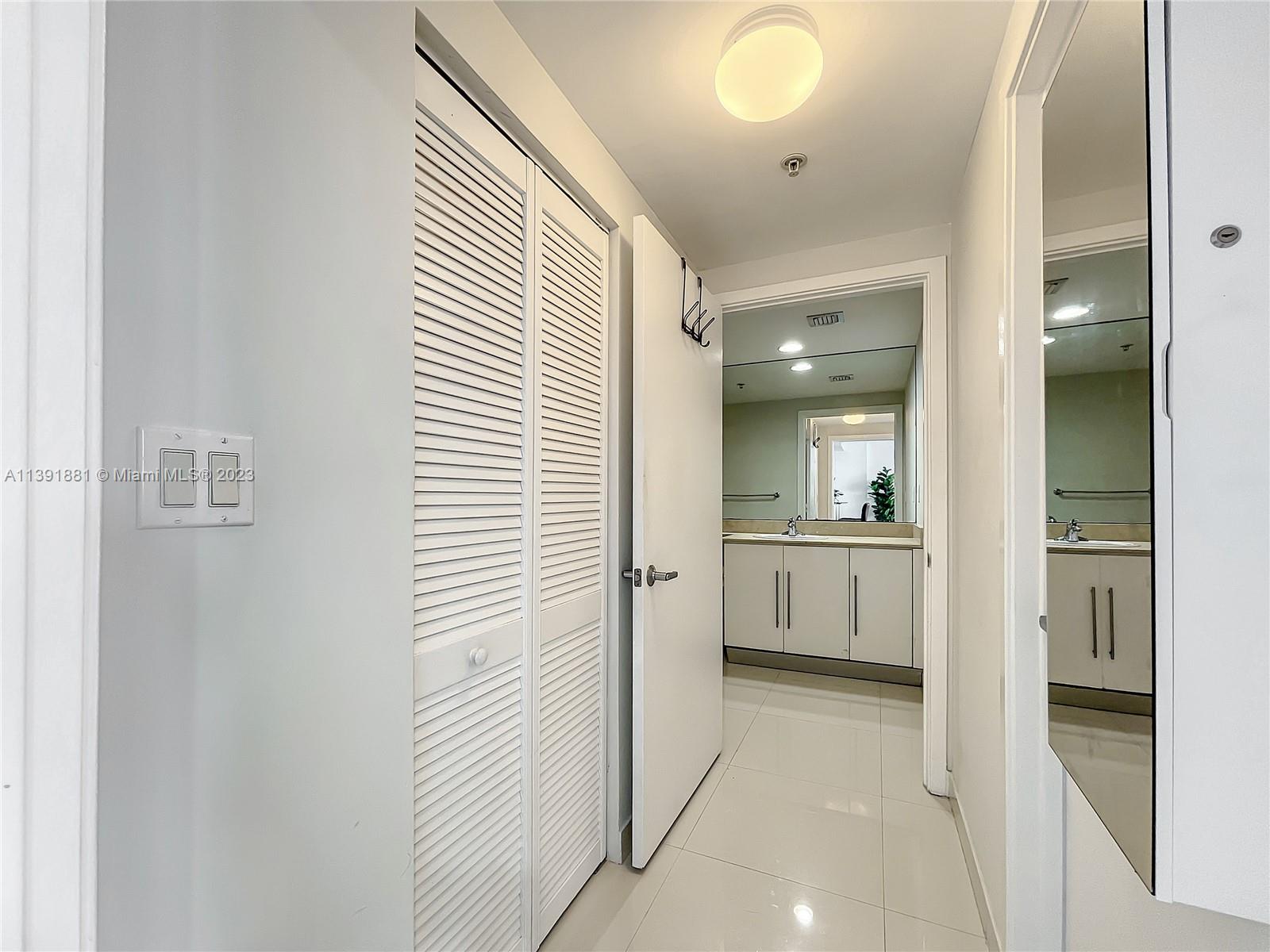 335 South Biscayne Boulevard, Unit 3103 Miami, FL 33131 - Photo 15 of 35 a bathroom with a sink and mirror