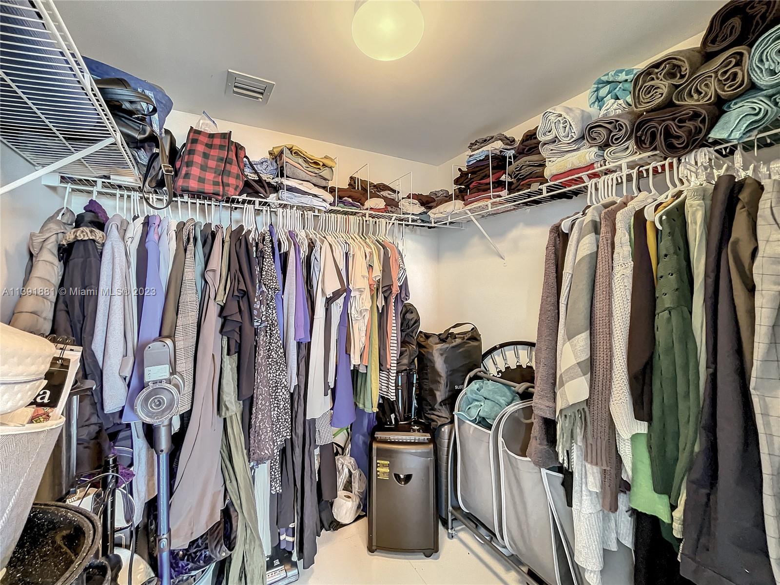 335 South Biscayne Boulevard, Unit 3103 Miami, FL 33131 - Photo 16 of 35 a view of walk in closet with clothes and shoes