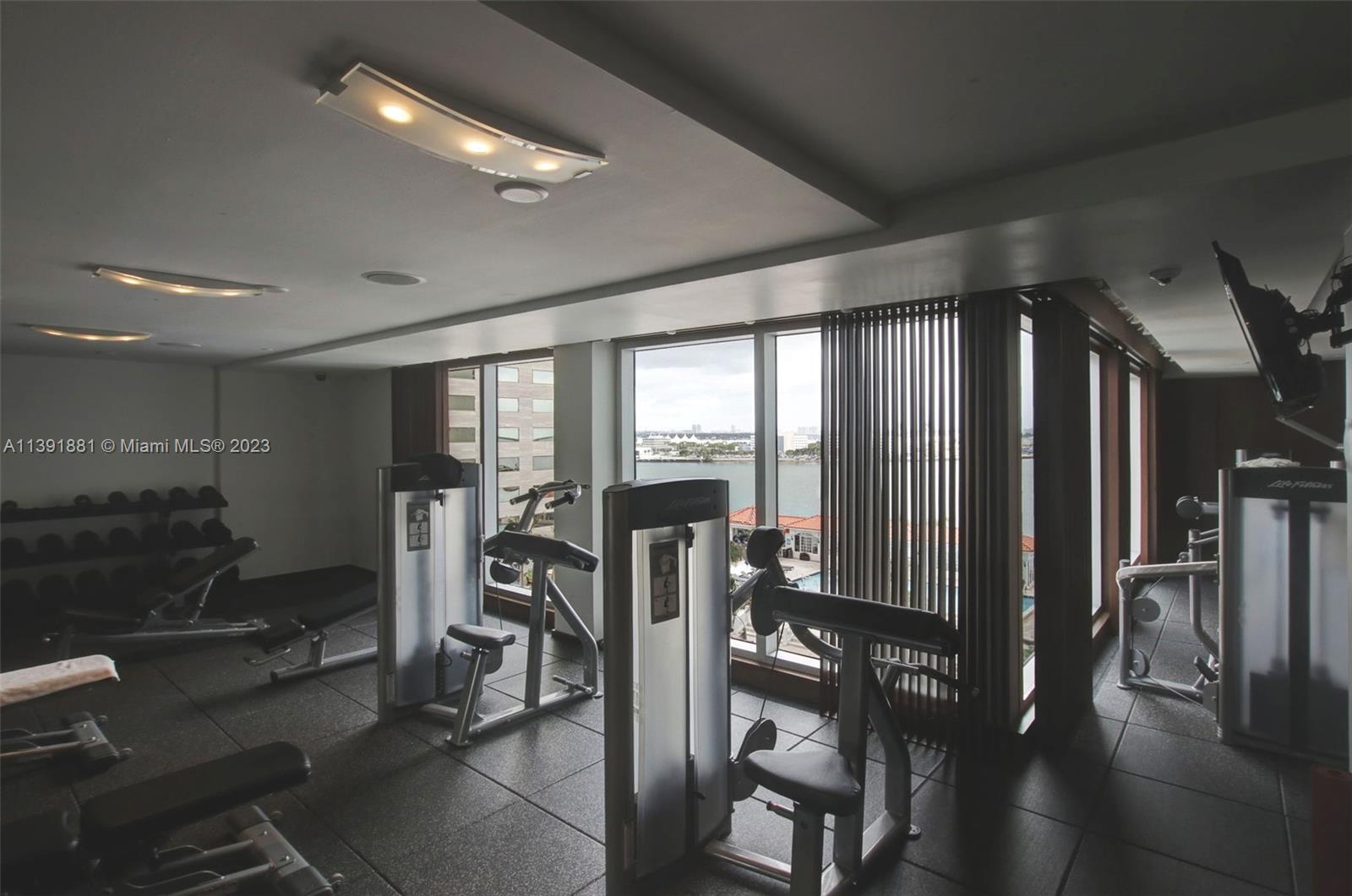 335 South Biscayne Boulevard, Unit 3103 Miami, FL 33131 - Photo 27 of 35 a view of a room with gym equipment