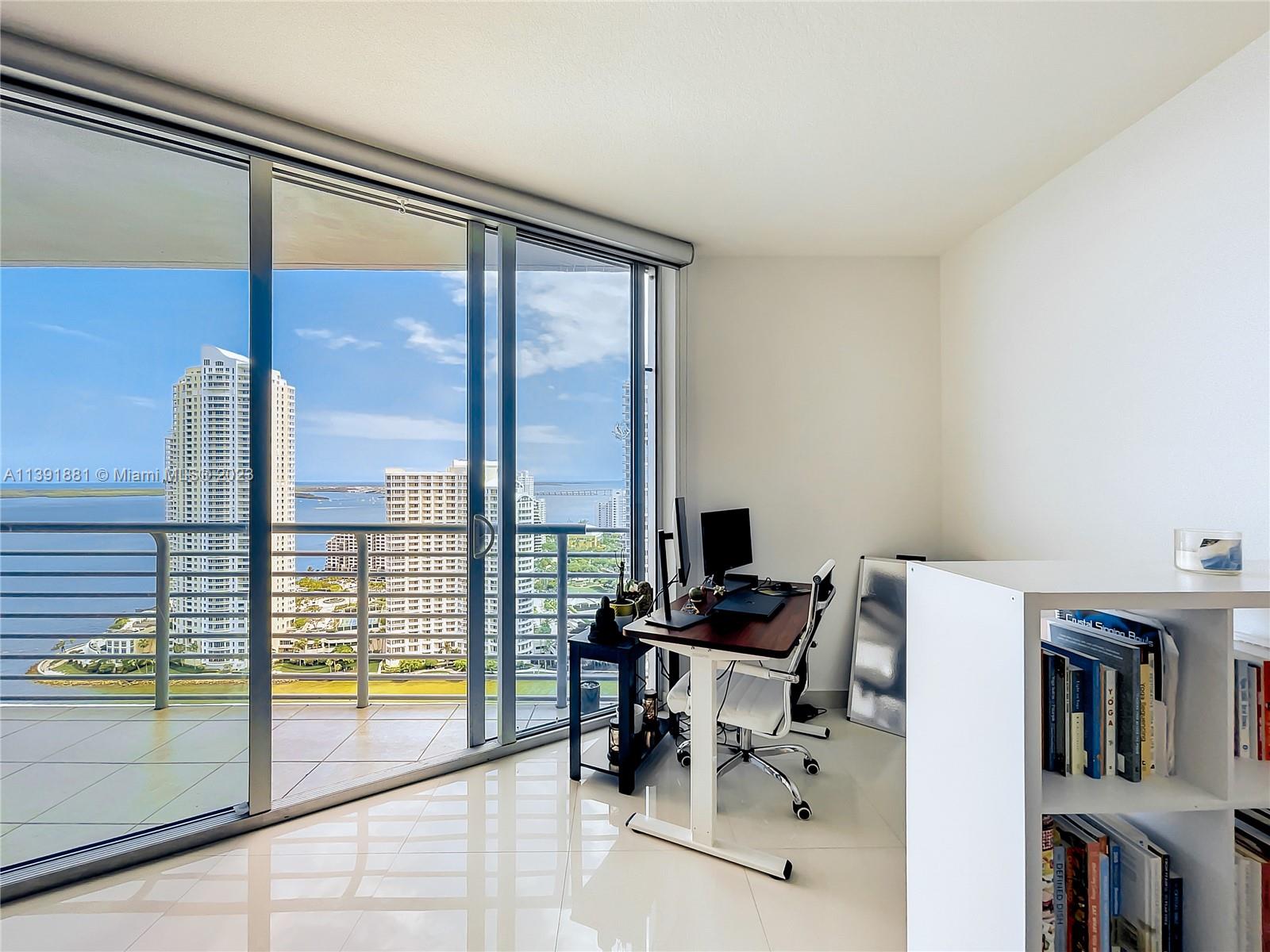 335 South Biscayne Boulevard, Unit 3103 Miami, FL 33131 - Photo 4 of 35 a view of workspace with furniture and floor to ceiling window