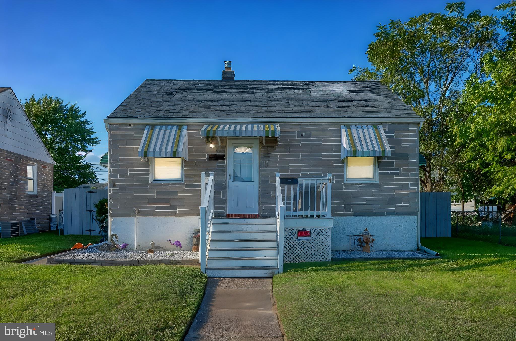 a front view of a house with a garden