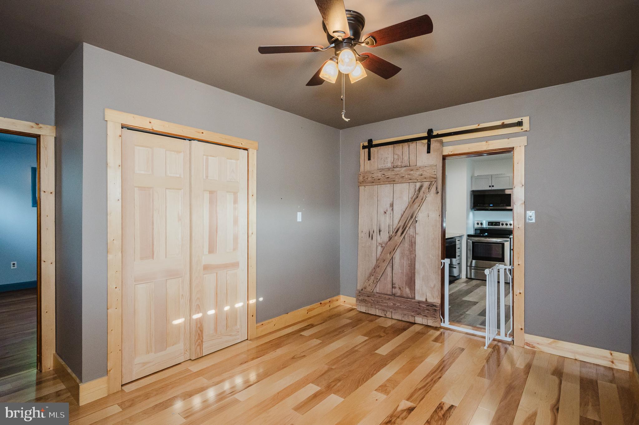 315 Pinewood Road Dundalk, MD 21222 - Photo 15 of 44 a view of a livingroom with wooden floor and a ceiling fan