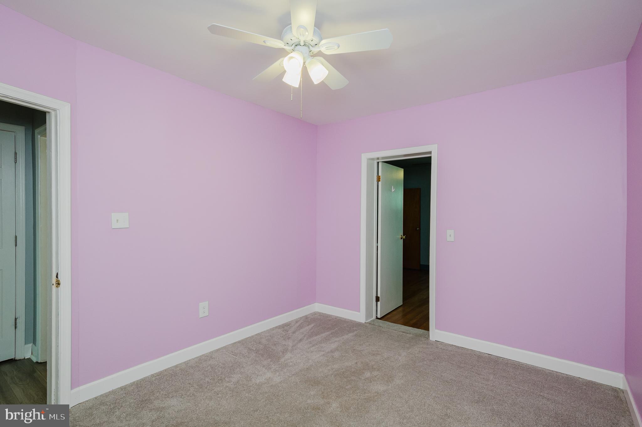 315 Pinewood Road Dundalk, MD 21222 - Photo 22 of 44 an empty room with a chandelier fan and a ceiling fan