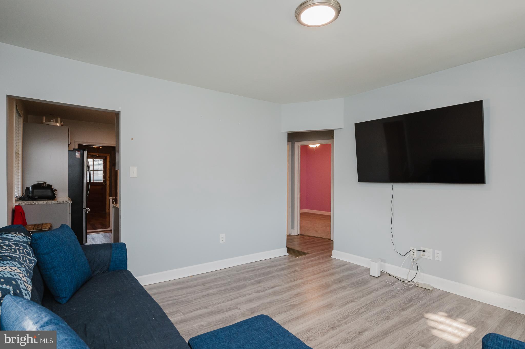 315 Pinewood Road Dundalk, MD 21222 - Photo 6 of 44 a living room with furniture and a flat screen tv