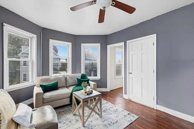 a living room with furniture and wooden floor