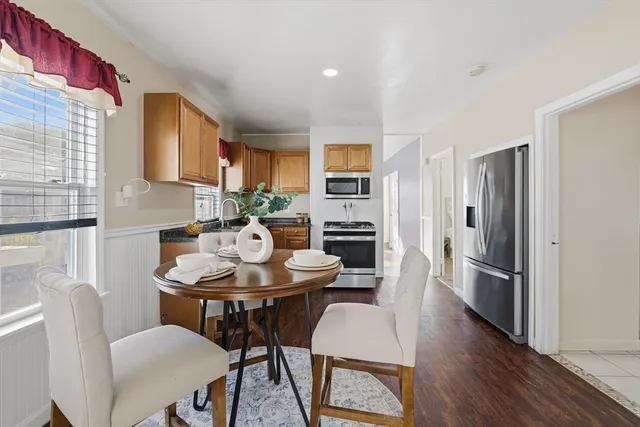 a view of a dining room with furniture window and wooden floor