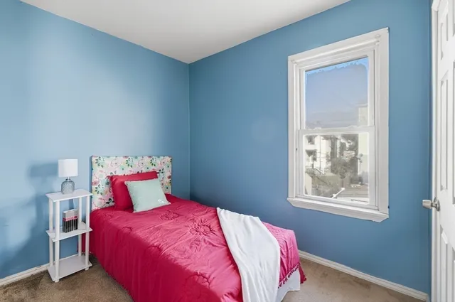 a bedroom with a bed and window