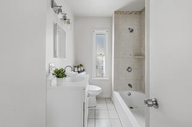 a bathroom with a toilet a sink and shower