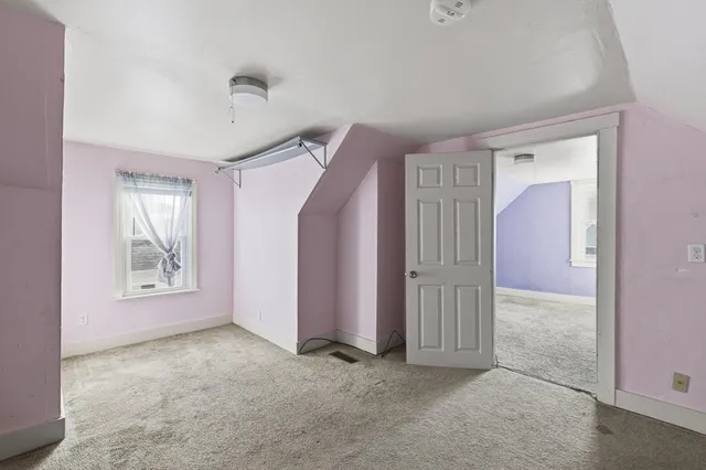 an empty room with windows and closet