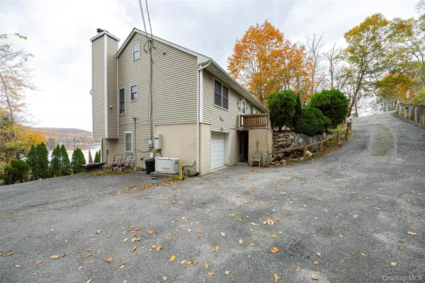 a view of a house with a yard and sitting area