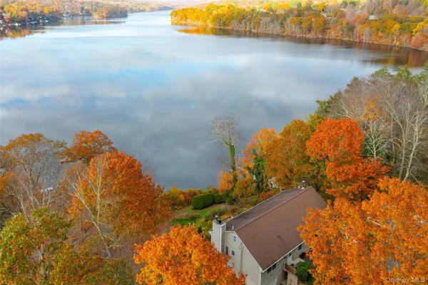 an aerial view of a house with a lake view