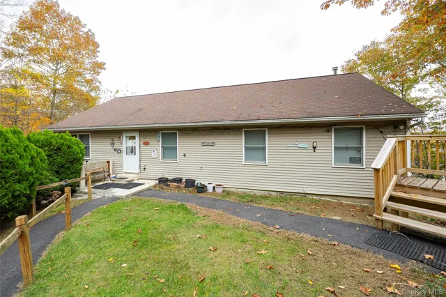a view of a house with pool and chairs