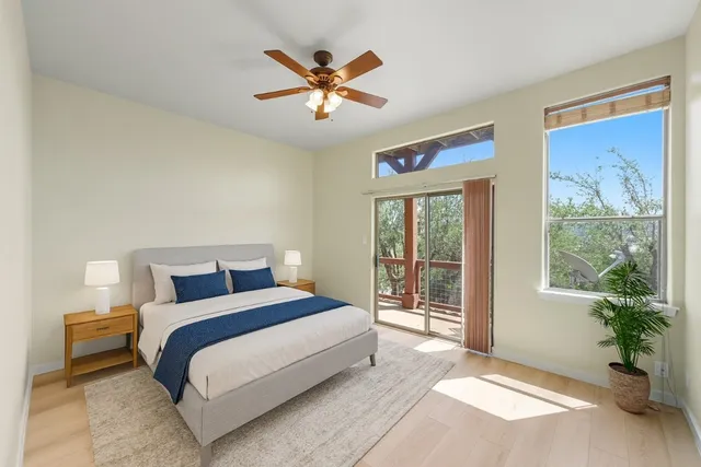 a bedroom with a large bed and a large window