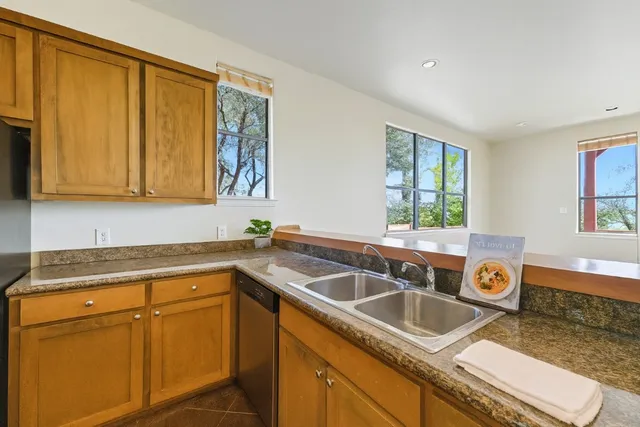 a kitchen that has a sink and a stove
