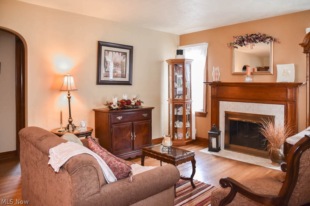 4222 7th Street Northwest Canton, OH 44708 - Photo 2 of 26 Living room with wood flooring and a fireplace.
