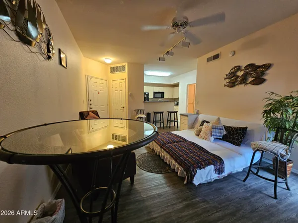 a living room with furniture and a wooden floor