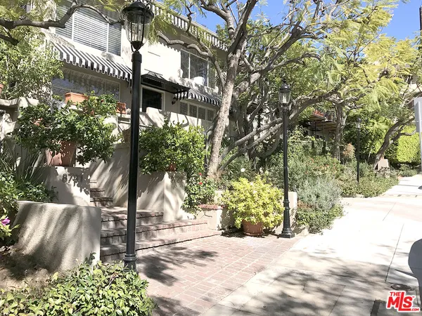 a pathway of a house with a yard