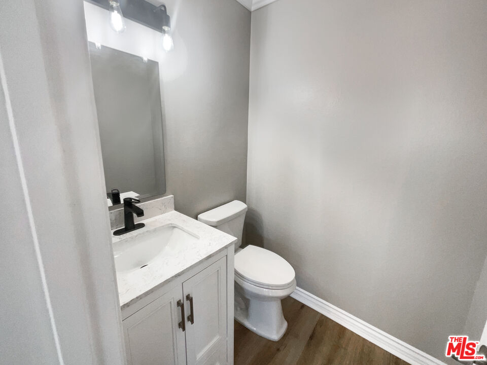 328 Valverde Avenue Brea, CA 92821 - Photo 15 of 21 a white toilet sitting next to a white sink and vanity