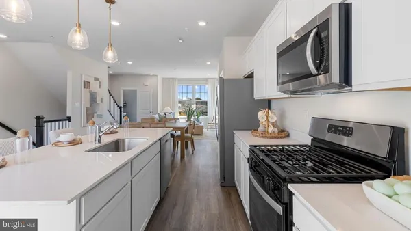 a kitchen with a sink stove and microwave