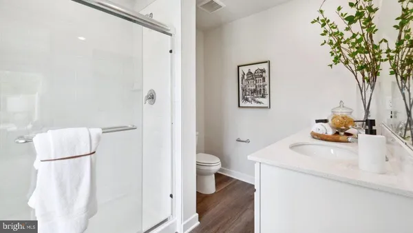 a bathroom with a sink a mirror and a shower