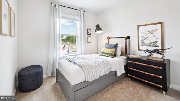 a bedroom with a bed and painting on the wall