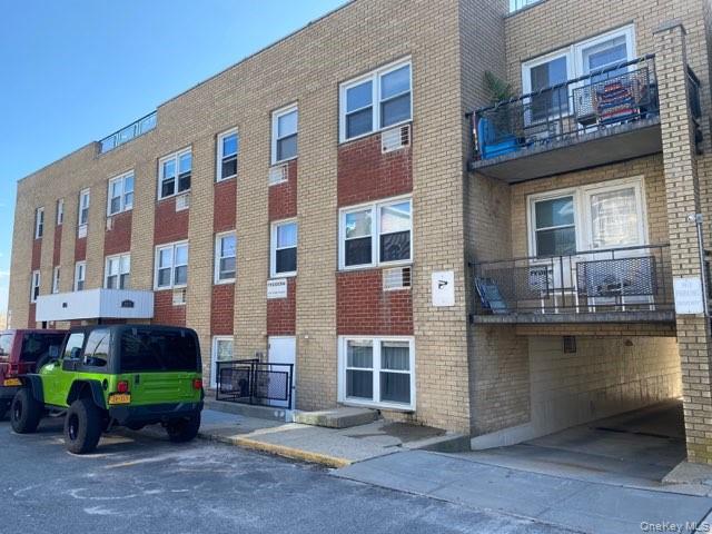951 Oceanfront, Unit 29 Long Beach, NY 11561 - Photo 4 of 5 a front view of a building with a garden and plants