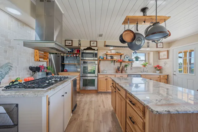 a kitchen with stainless steel appliances granite countertop a sink and cabinets