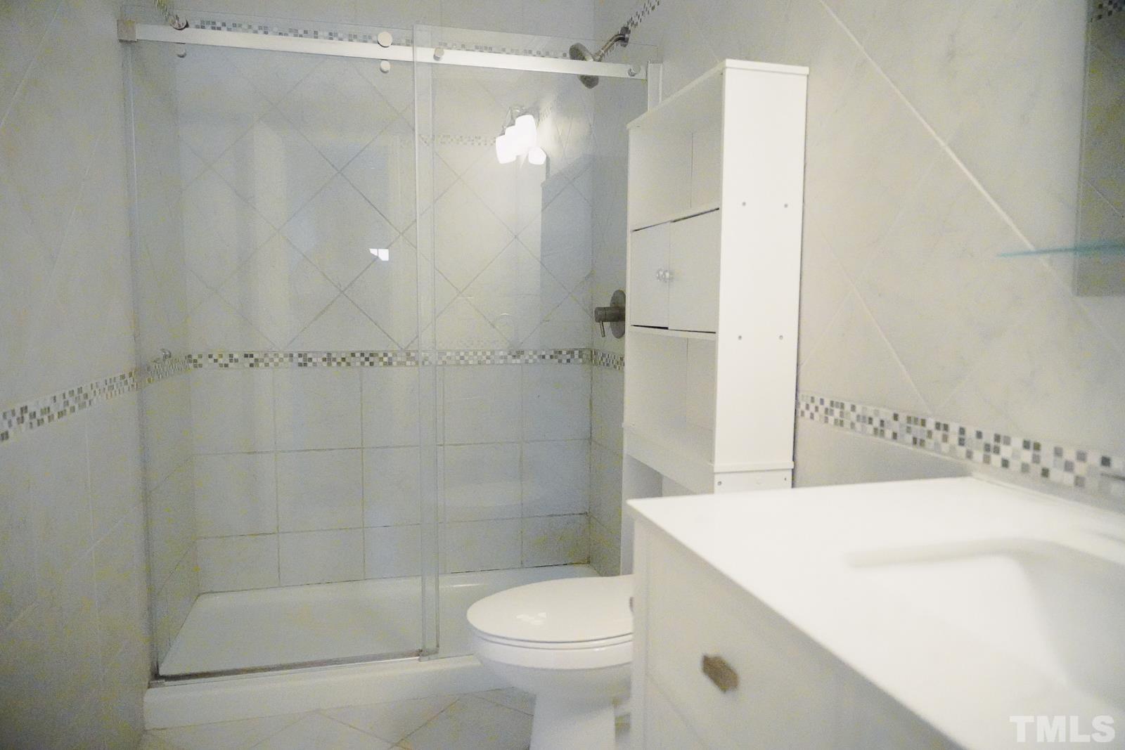 1320 South State Street, Unit A Raleigh, NC 27610 - Photo 14 of 20 a bathroom with a shower and a toilet