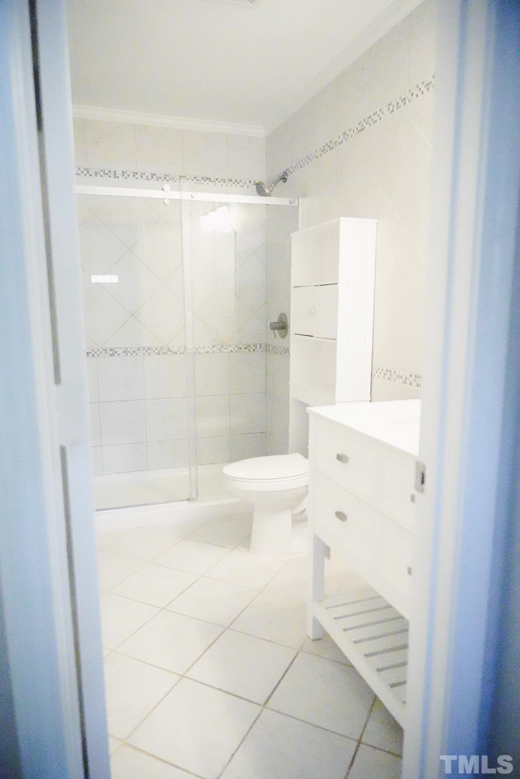 1320 South State Street, Unit A Raleigh, NC 27610 - Photo 16 of 20 a bathroom with a bathtub and a shower