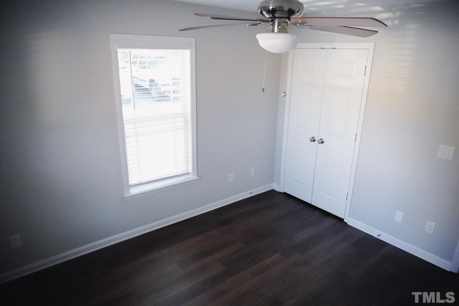 1320 South State Street, Unit A Raleigh, NC 27610 - Photo 9 of 20 an empty room with a window and a ceiling fan